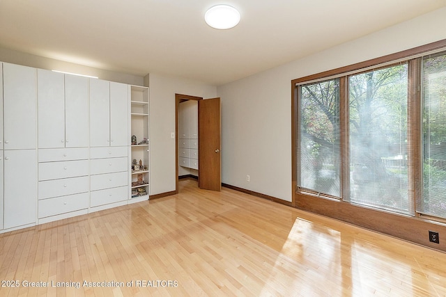 1210 Whittier Dr, East Lansing, MI 48823 - unfurnished bedroom featuring baseboards, a closet, and light wood-type flooring