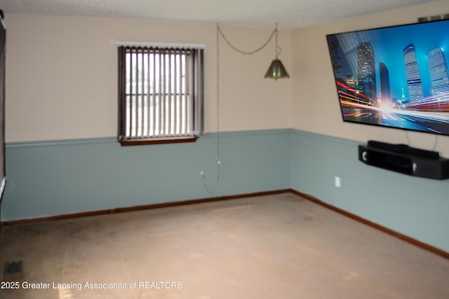 unfurnished room featuring baseboards and carpet flooring