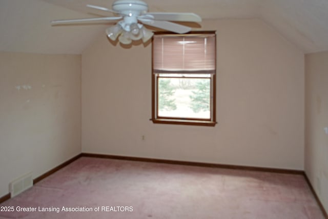 additional living space with visible vents, a ceiling fan, light colored carpet, and lofted ceiling