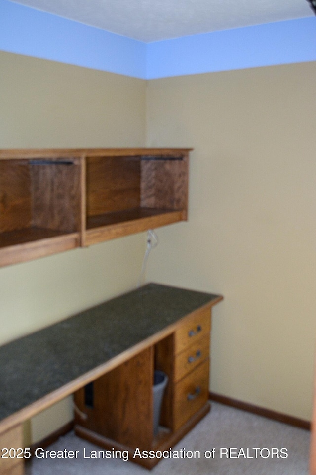 unfurnished office with baseboards