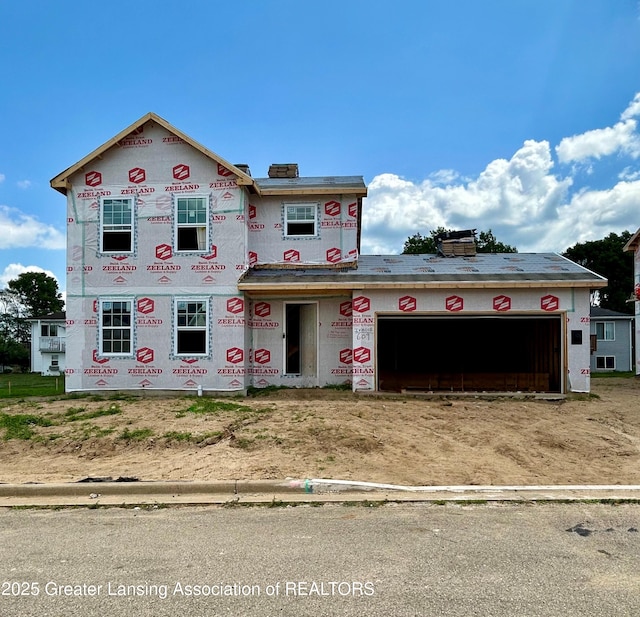 609 Muirfield Dr, Eaton Rapids, MI 48827 - property in mid-construction with a garage, driveway, and a chimney