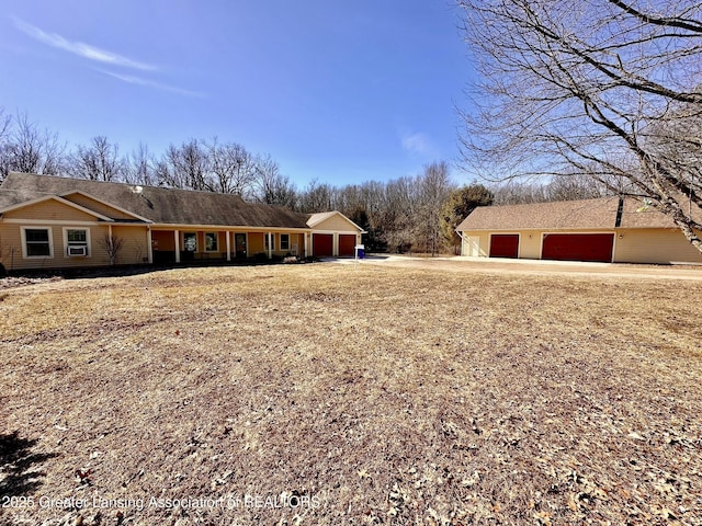 single story home featuring a garage and driveway