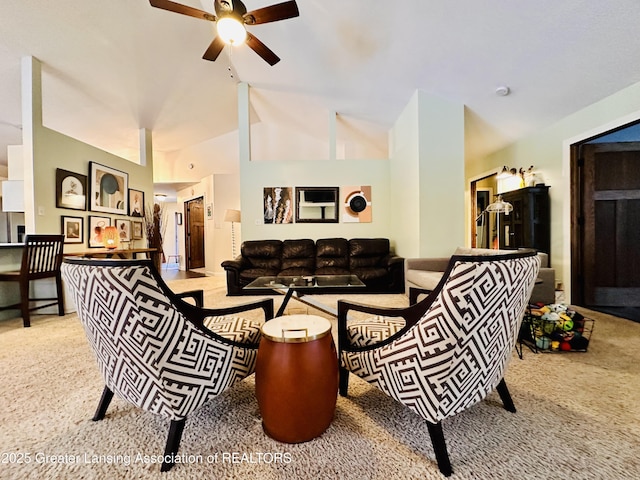 living area with high vaulted ceiling, a ceiling fan, and carpet floors