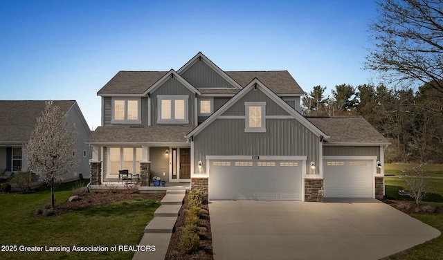 craftsman-style home with a porch, driveway, stone siding, and a garage