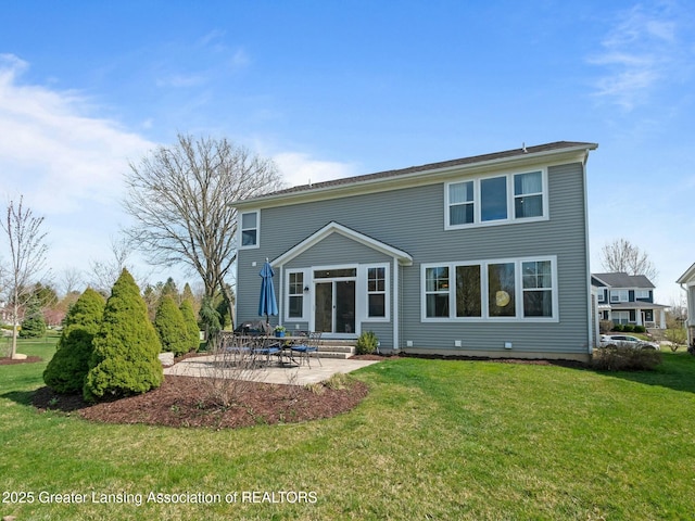 back of house with a patio area, a lawn, and entry steps