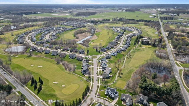 drone / aerial view with view of golf course and a residential view