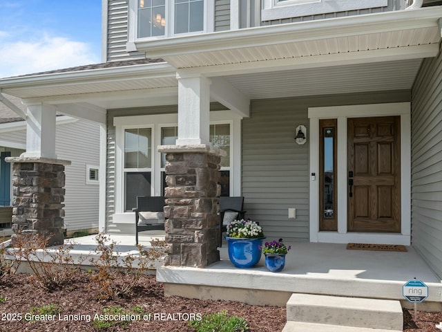 view of exterior entry featuring a porch