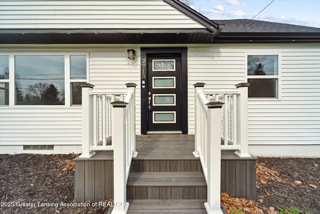 property entrance featuring crawl space and a shingled roof