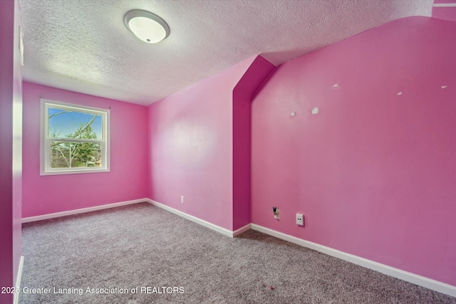 additional living space featuring carpet floors, a textured ceiling, and baseboards