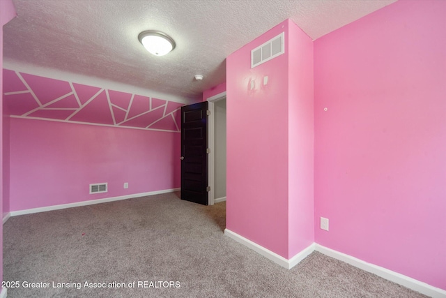 interior space with a textured ceiling, visible vents, and carpet