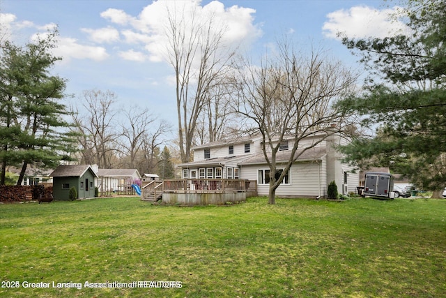 view of yard with a deck and an outdoor structure
