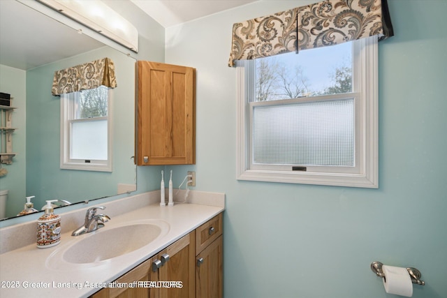 bathroom featuring vanity and toilet