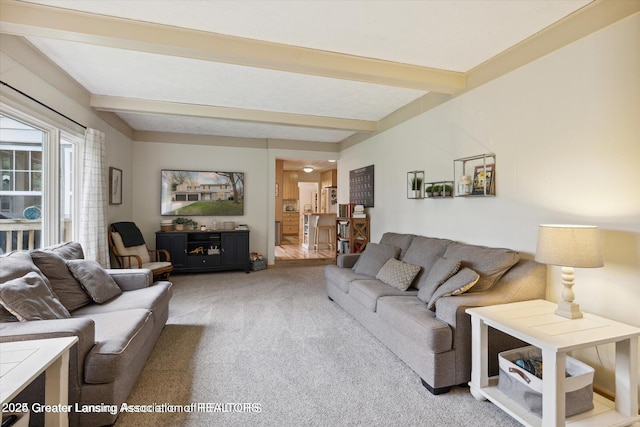 living room featuring light colored carpet and beamed ceiling