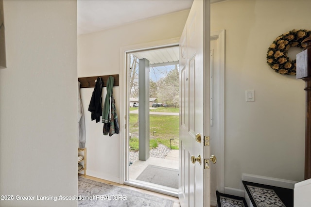doorway featuring baseboards