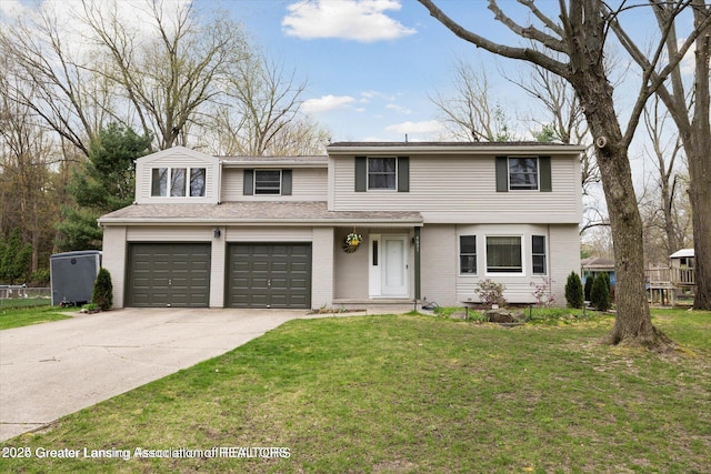 traditional home with an attached garage, concrete driveway, a front lawn, and brick siding