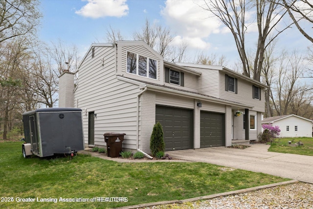 view of front of home with brick siding, a front lawn, a garage, and driveway