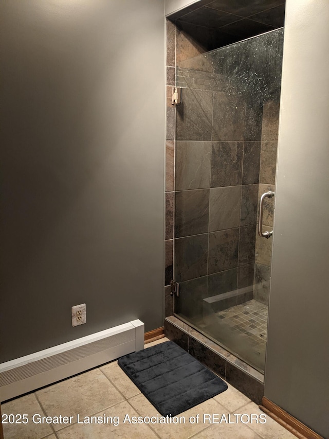 full bathroom with tile patterned floors, baseboards, and a stall shower