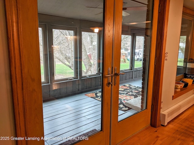 entryway featuring a wealth of natural light, french doors, and hardwood / wood-style flooring
