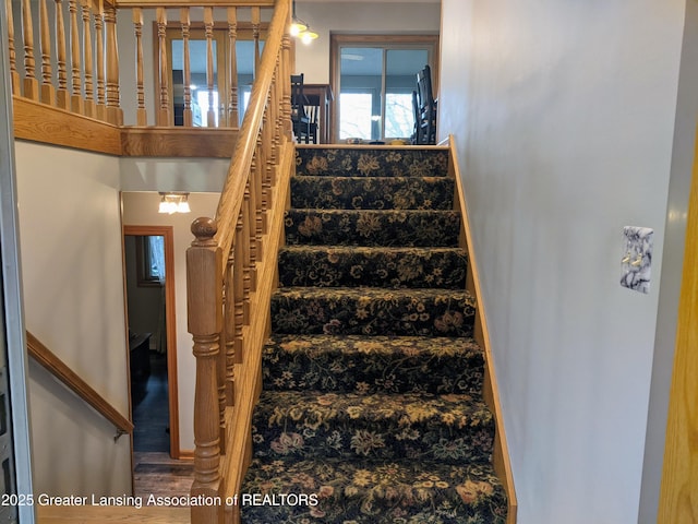 stairway featuring wood finished floors