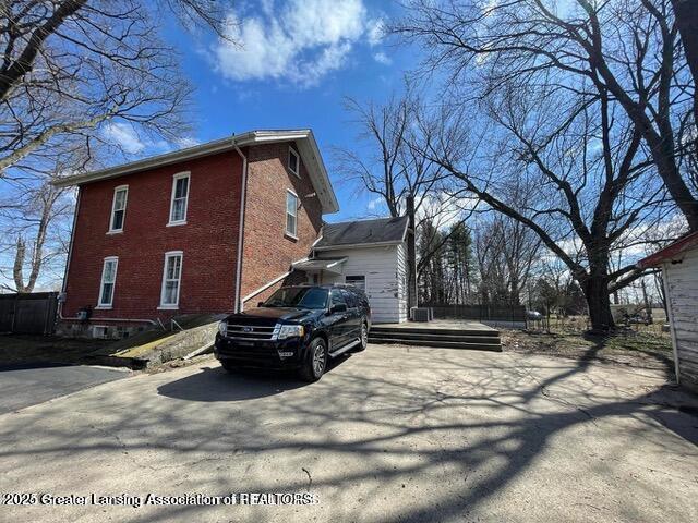11100 Anderson Rd, Litchfield, MI 49252 - view of side of home featuring brick siding and driveway