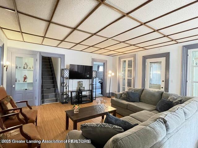 11100 Anderson Rd, Litchfield, MI 49252 - living area with wood finished floors, stairway, and built in shelves