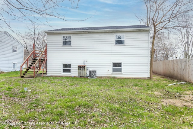 5026 Delray Dr, Lansing, MI 48910 - rear view of property with stairs, a yard, cooling unit, and fence