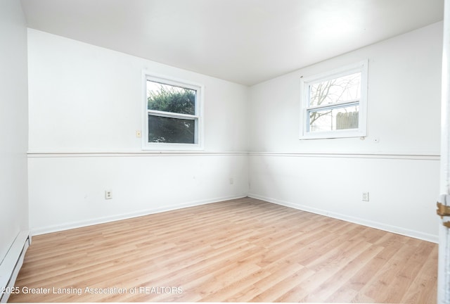 5026 Delray Dr, Lansing, MI 48910 - empty room featuring a baseboard radiator, light wood finished floors, and baseboards