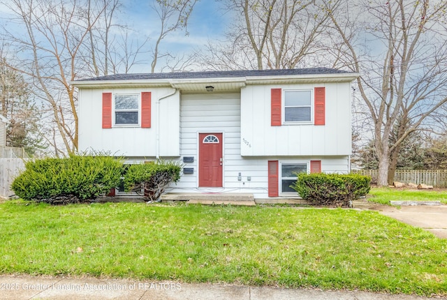 5026 Delray Dr, Lansing, MI 48910 - raised ranch with board and batten siding, fence, and a front lawn