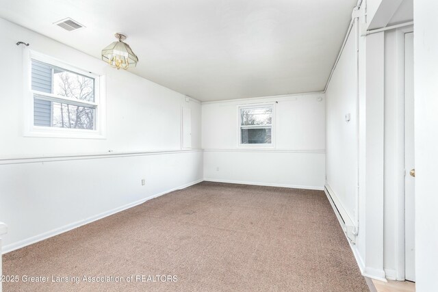 5026 Delray Dr, Lansing, MI 48910 - spare room featuring visible vents, a notable chandelier, carpet, and a wealth of natural light