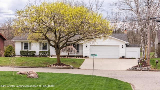 view of front facade featuring driveway, a front yard, and a garage