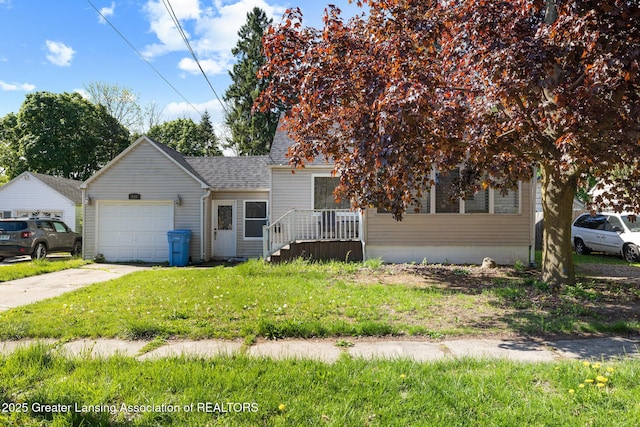 610 Spokane Ave, Lansing, MI 48910 - view of front of property with an attached garage, concrete driveway, a front yard, and roof with shingles