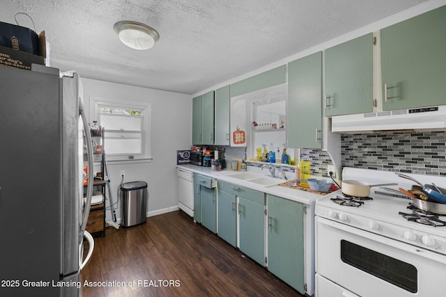 610 Spokane Ave, Lansing, MI 48910 - kitchen featuring white appliances, under cabinet range hood, a textured ceiling, backsplash, and a sink