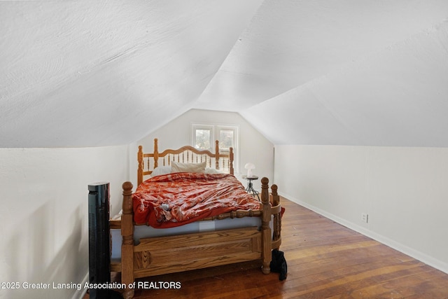 610 Spokane Ave, Lansing, MI 48910 - bedroom featuring wood-type flooring, baseboards, and vaulted ceiling