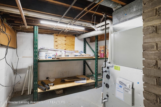 610 Spokane Ave, Lansing, MI 48910 - unfinished basement with heating unit and a workshop area