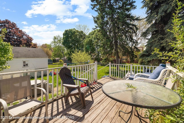 610 Spokane Ave, Lansing, MI 48910 - wooden deck with outdoor dining area and central air condition unit