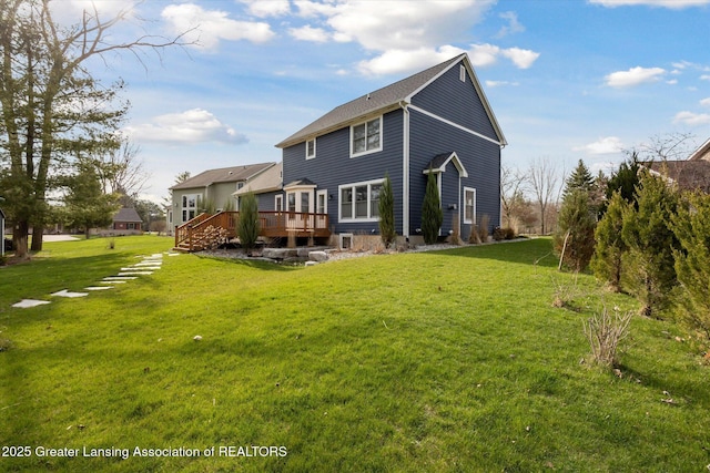 3430 Hawthorne Woods Pkwy, Dewitt, MI 48820 - rear view of house featuring a yard and a wooden deck