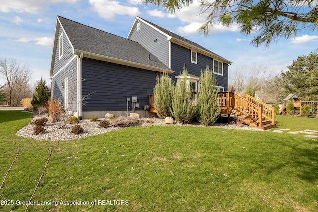 3430 Hawthorne Woods Pkwy, Dewitt, MI 48820 - back of house with a yard, a wooden deck, and roof with shingles