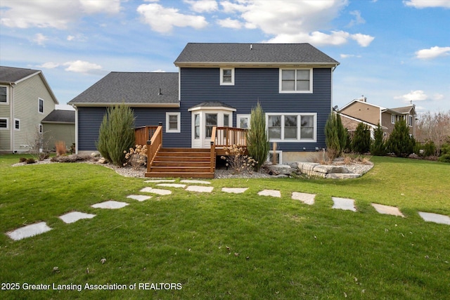 3430 Hawthorne Woods Pkwy, Dewitt, MI 48820 - rear view of property featuring a deck and a lawn