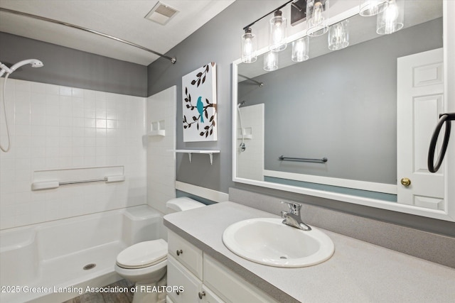 3430 Hawthorne Woods Pkwy, Dewitt, MI 48820 - bathroom featuring toilet, vanity, visible vents, and walk in shower