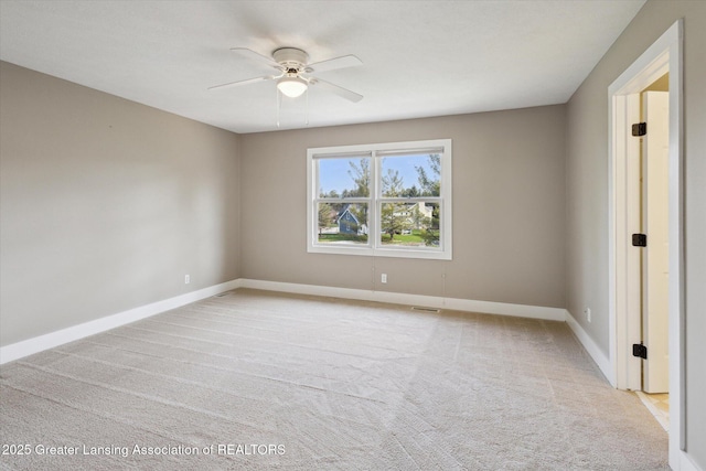 3430 Hawthorne Woods Pkwy, Dewitt, MI 48820 - empty room featuring visible vents, light colored carpet, baseboards, and ceiling fan