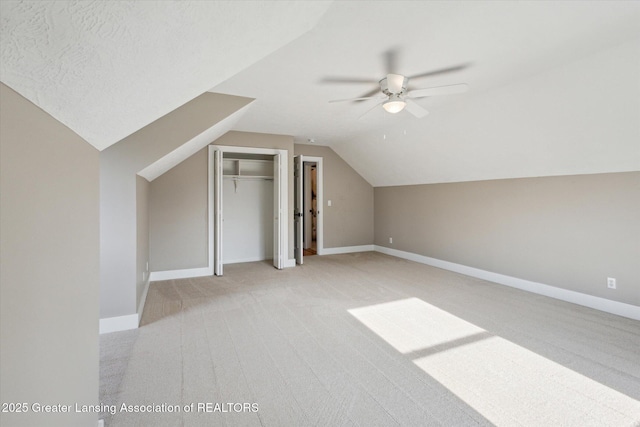 3430 Hawthorne Woods Pkwy, Dewitt, MI 48820 - bonus room with baseboards, light colored carpet, vaulted ceiling, and a ceiling fan