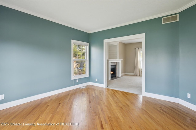 3430 Hawthorne Woods Pkwy, Dewitt, MI 48820 - unfurnished living room with a fireplace with flush hearth, visible vents, ornamental molding, and wood finished floors