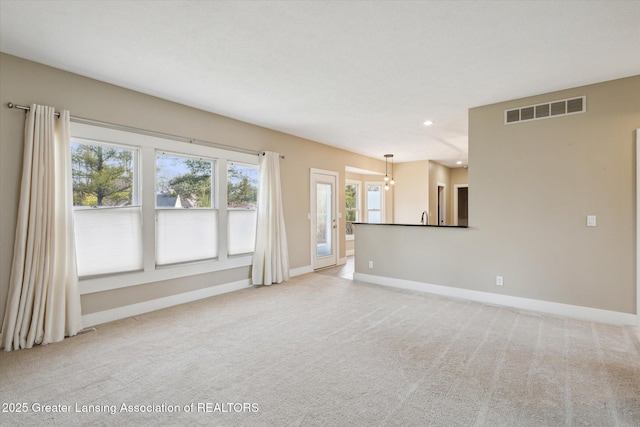 3430 Hawthorne Woods Pkwy, Dewitt, MI 48820 - unfurnished living room with light carpet, recessed lighting, visible vents, and baseboards