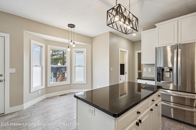 3430 Hawthorne Woods Pkwy, Dewitt, MI 48820 - kitchen featuring stainless steel fridge with ice dispenser, dark countertops, white cabinetry, and baseboards
