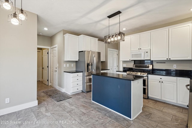 3430 Hawthorne Woods Pkwy, Dewitt, MI 48820 - kitchen featuring stainless steel appliances, a kitchen island, white cabinetry, and dark countertops