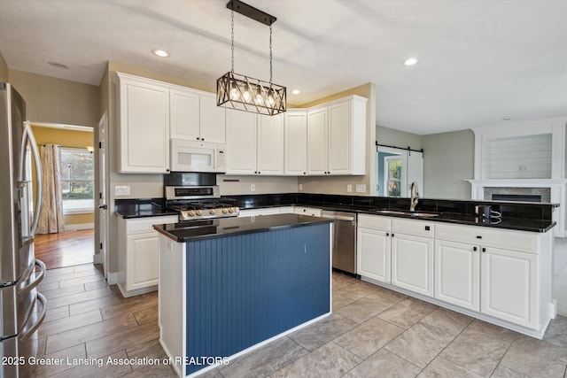 3430 Hawthorne Woods Pkwy, Dewitt, MI 48820 - kitchen featuring plenty of natural light, a sink, dark countertops, a peninsula, and stainless steel appliances