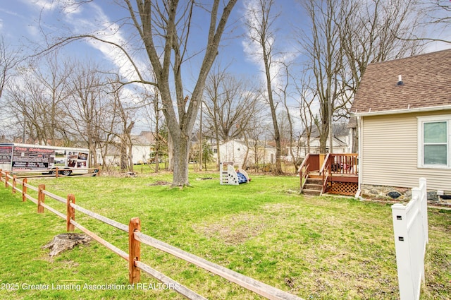 view of yard with a wooden deck and fence
