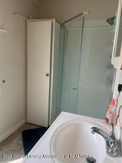 full bathroom with a shower stall