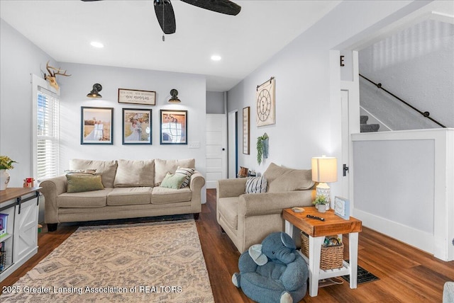 living area featuring recessed lighting, dark wood-type flooring, a ceiling fan, and stairs