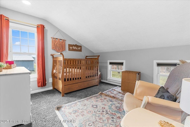carpeted bedroom featuring baseboards and vaulted ceiling